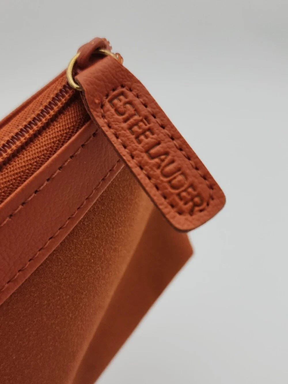 Estee Lauder Sleek Burnt Orange Zip Pouch with Gold Grommets